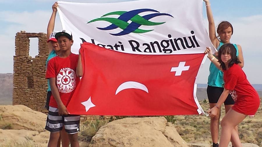 Te Aitanga a Pōkai Whenua students holding Tauranga Moana flags at Oraibi in the Hopi Nation
